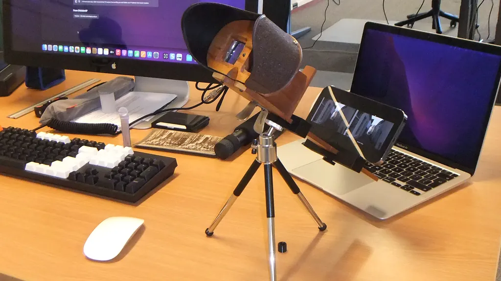An iPhone in a 3D-printed holder, mounted on a Holmes stereoviewer
